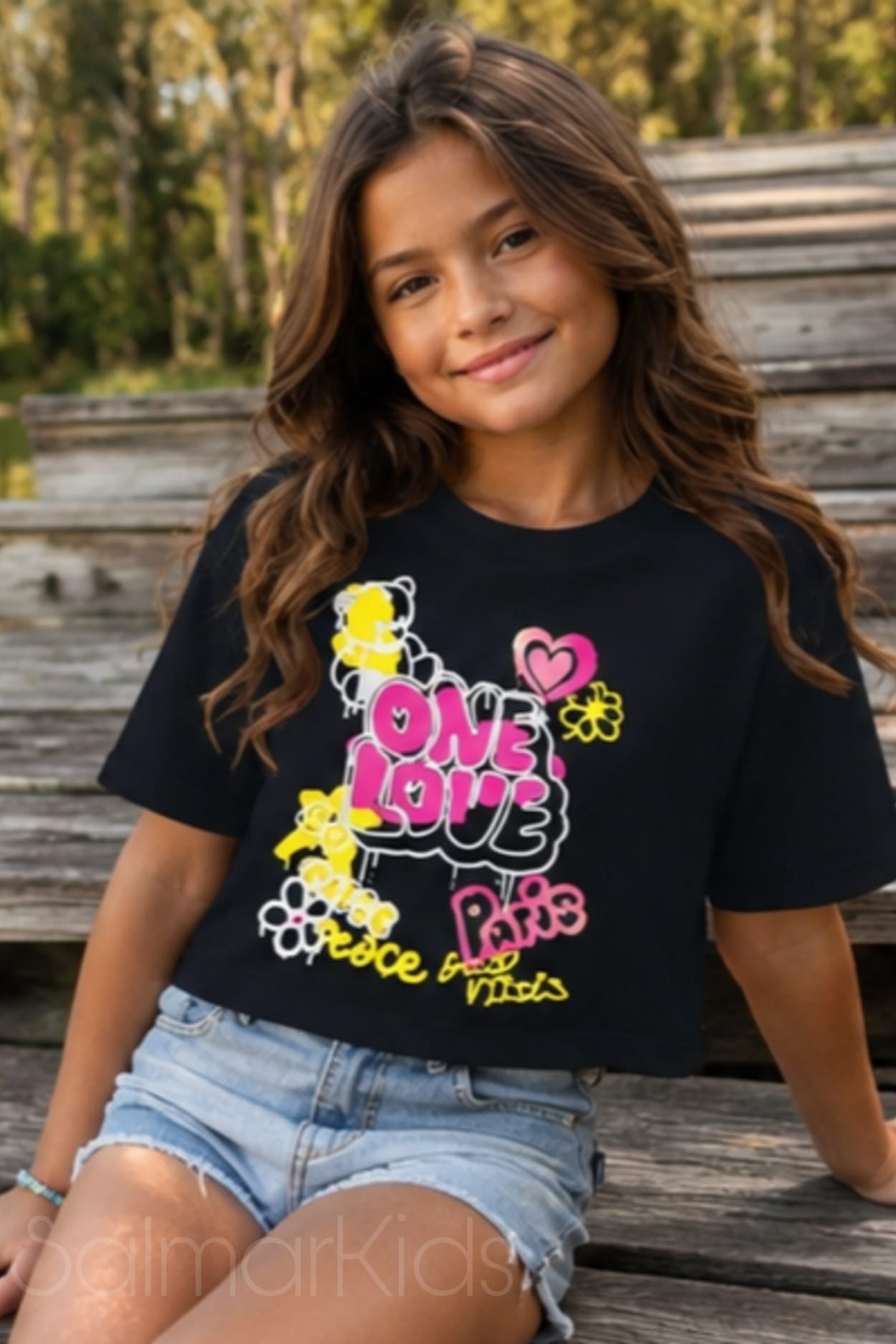 Uma t-shirt cheia de energia e estilo para as meninas que adoram se destacar! Com estampado colorido "One Love" em tons vibrantes de rosa, amarelo e branco, esta t-shirt é perfeita para os dias quentes de verão.

✨ Disponível em: Verde, Rosa e Preto 🌸 Estampado: One Love / Paris / Peace & Vibes 👕 Corte: Cropped descontraído 🌿 Material: 100% algodão (fresco e confortável)

Ideal para combinar com calções, calças de ganga ou saia — o look perfeito para a miúda cheia de personalidade!